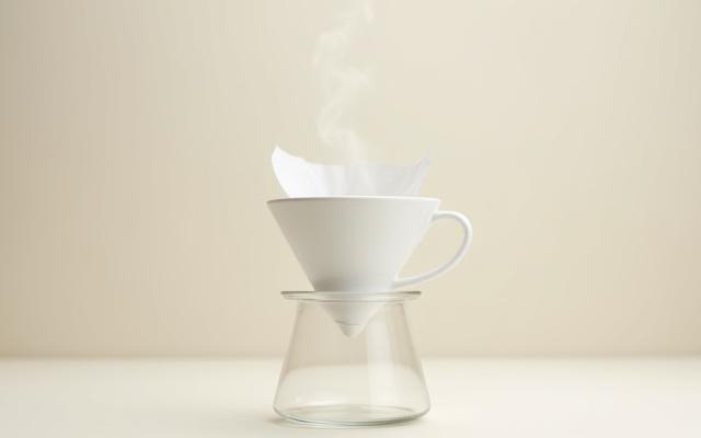 A Hario V60 ceramic dripper with a filter, ready for brewing.